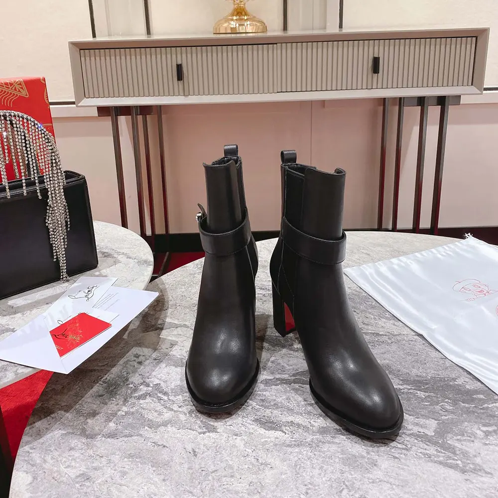 Close-up of black calf leather and red sole on Christian Louboutin boots