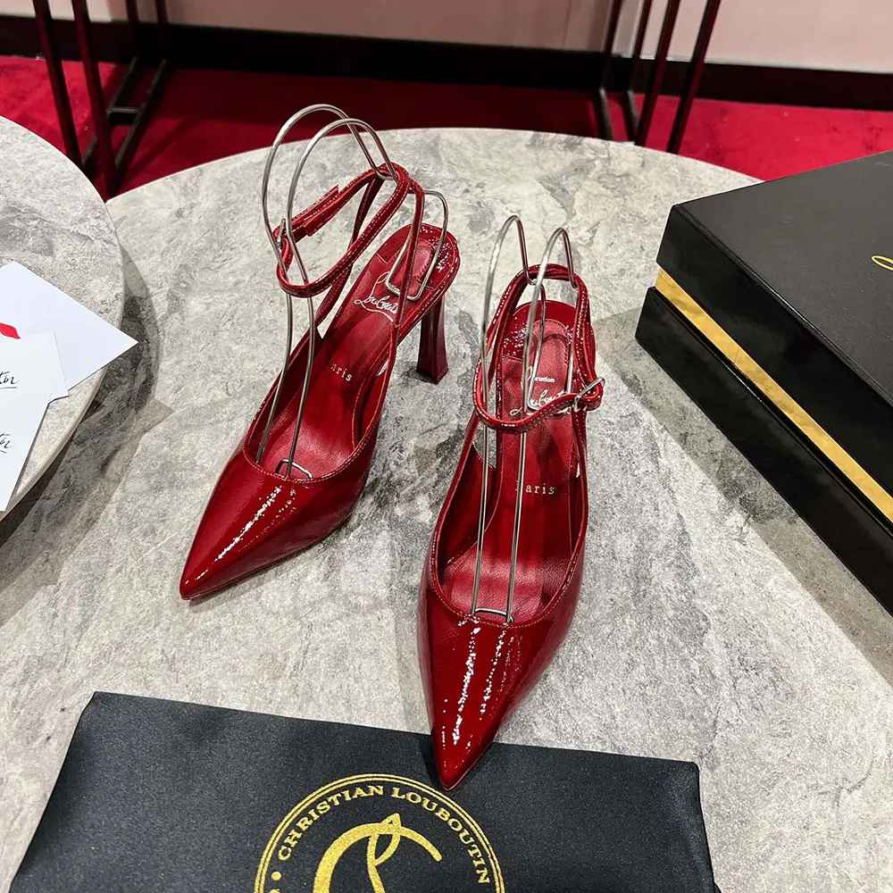 Close-up on red patent leather straps of Christian Louboutin Women Condora Strap Pumps