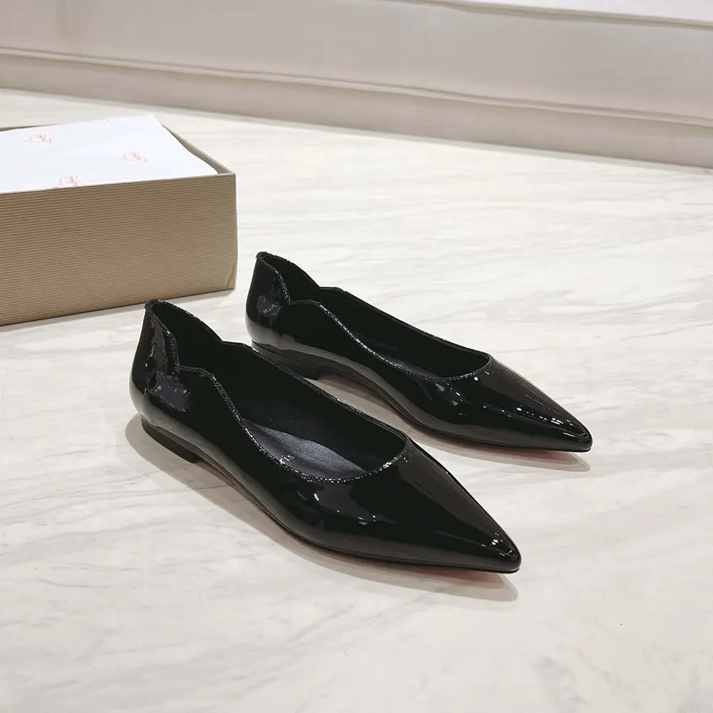 Close-up of glossy patent leather and signature red sole on Hot Chickita Ballerinas