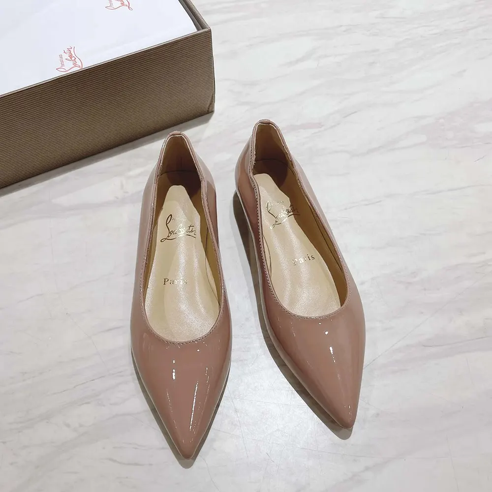 Close-up on glossy sandy patent leather upper with red sole detail