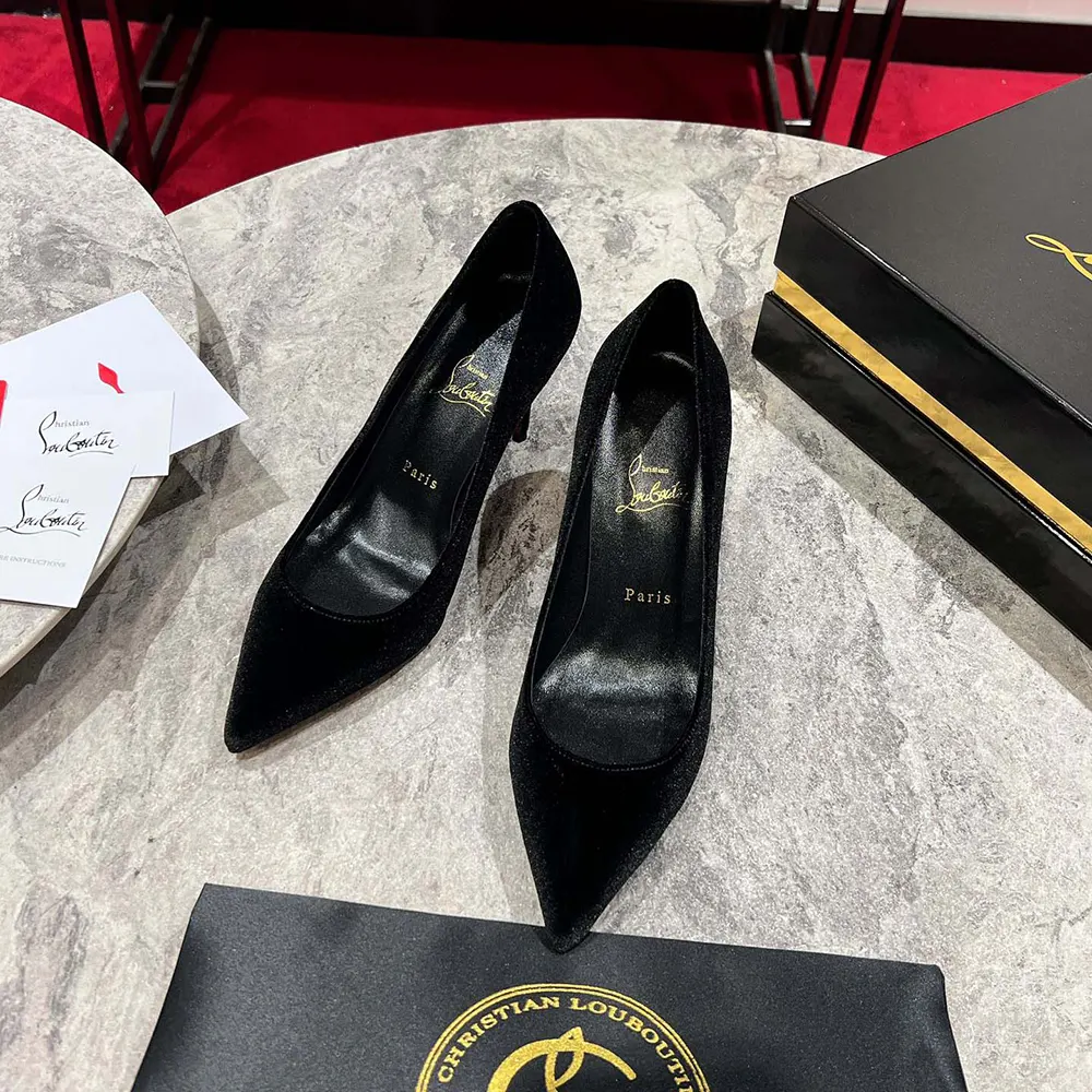 Close-up on black veau velours texture and signature red sole detail