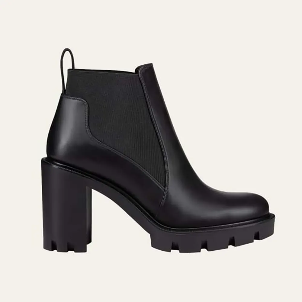 Close-up on elastic panel and signature red sole of booties