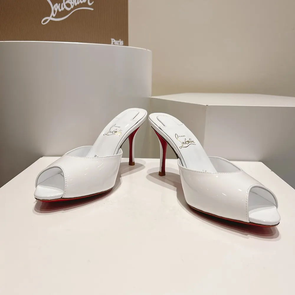 Close-up on glossy patent calfskin and signature red sole detail