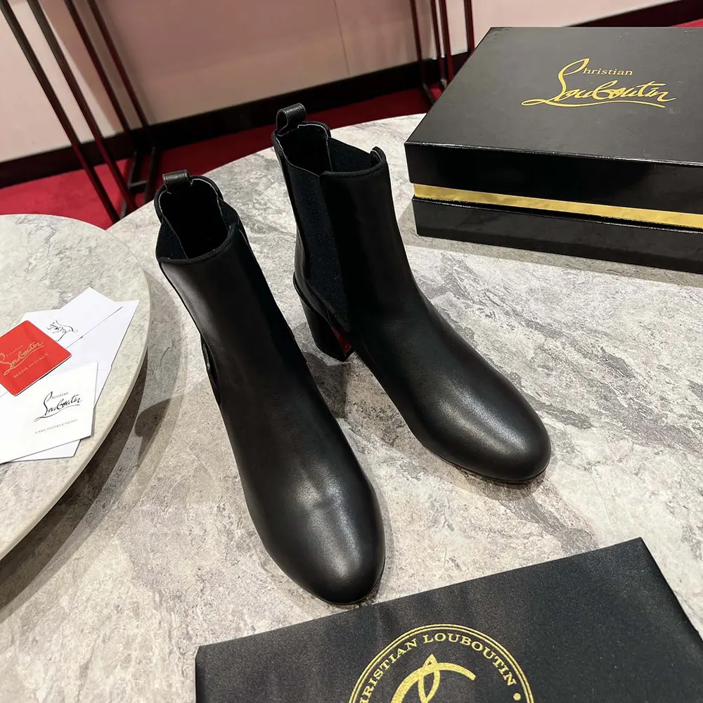 Close-up of black calf leather and elastic detail on Christian Louboutin Turelastic boots