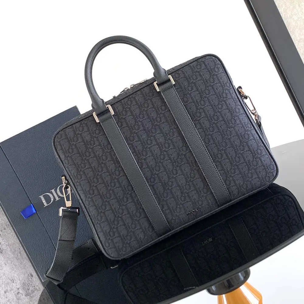 Close-up of black grained calfskin and zip hardware on briefcase