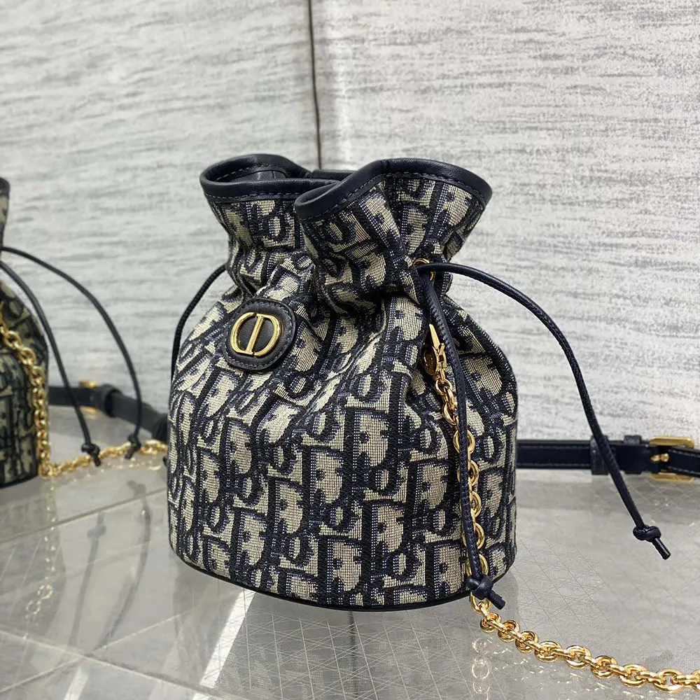 Side angle showing compact silhouette of Dior Women 30 Montaigne Mini Bucket Bag