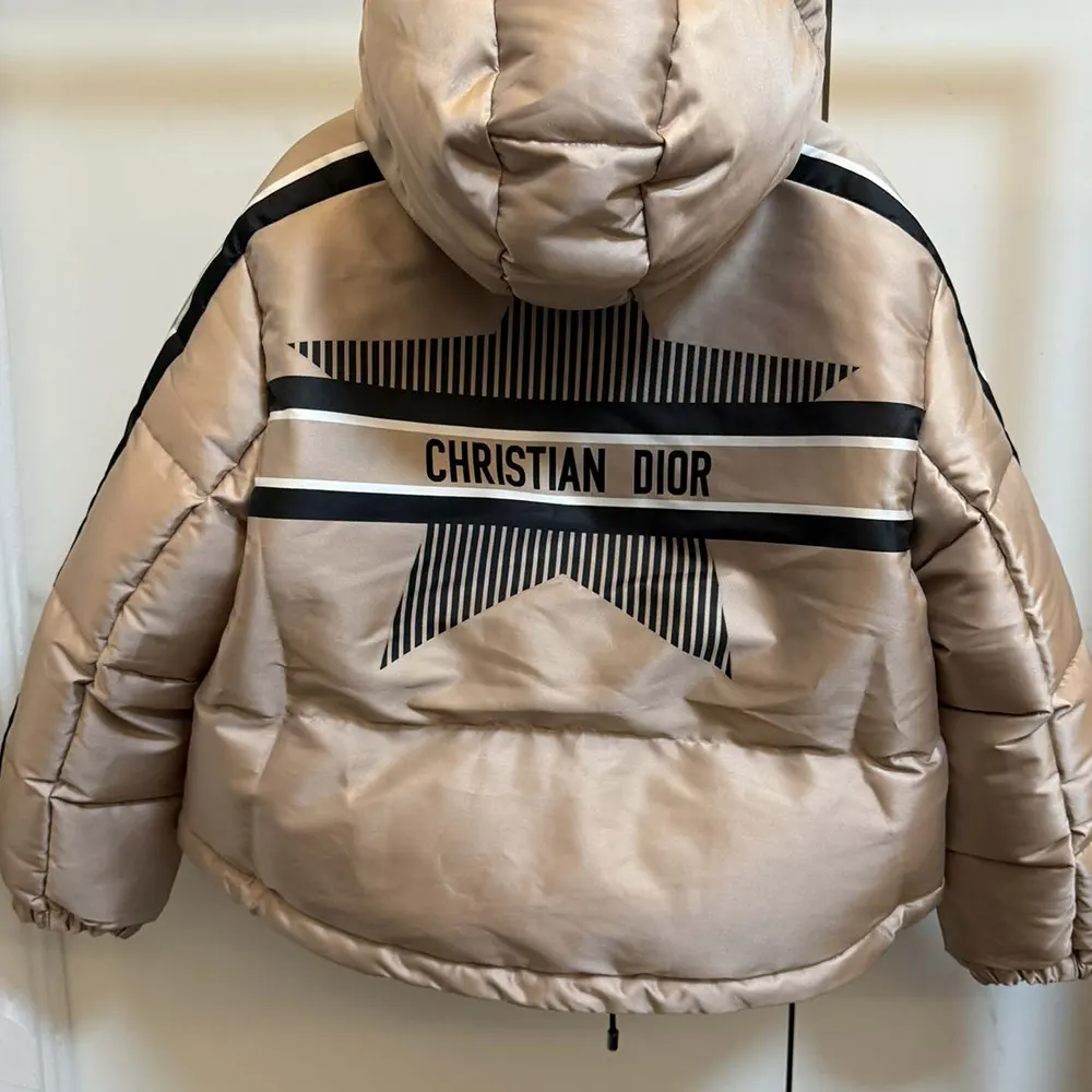 Side angle showing cropped silhouette and hood of Dior Women DiorAlps Puffer Jacket