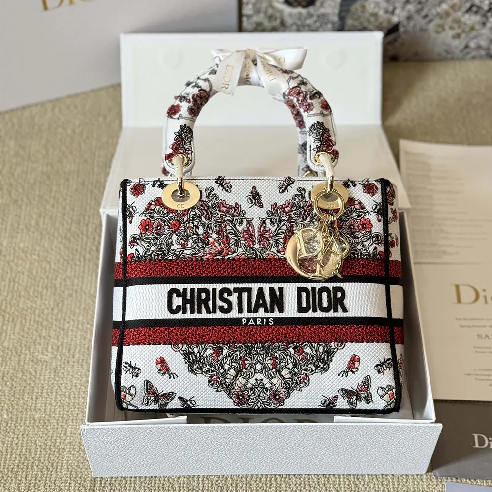 Close-up of white embroidery and silver hardware on Dior Women Dioramour bag