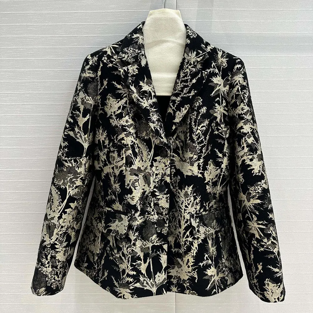 Close-up of gold-tone Dior Chardons motif embroidery on black fabric jacket