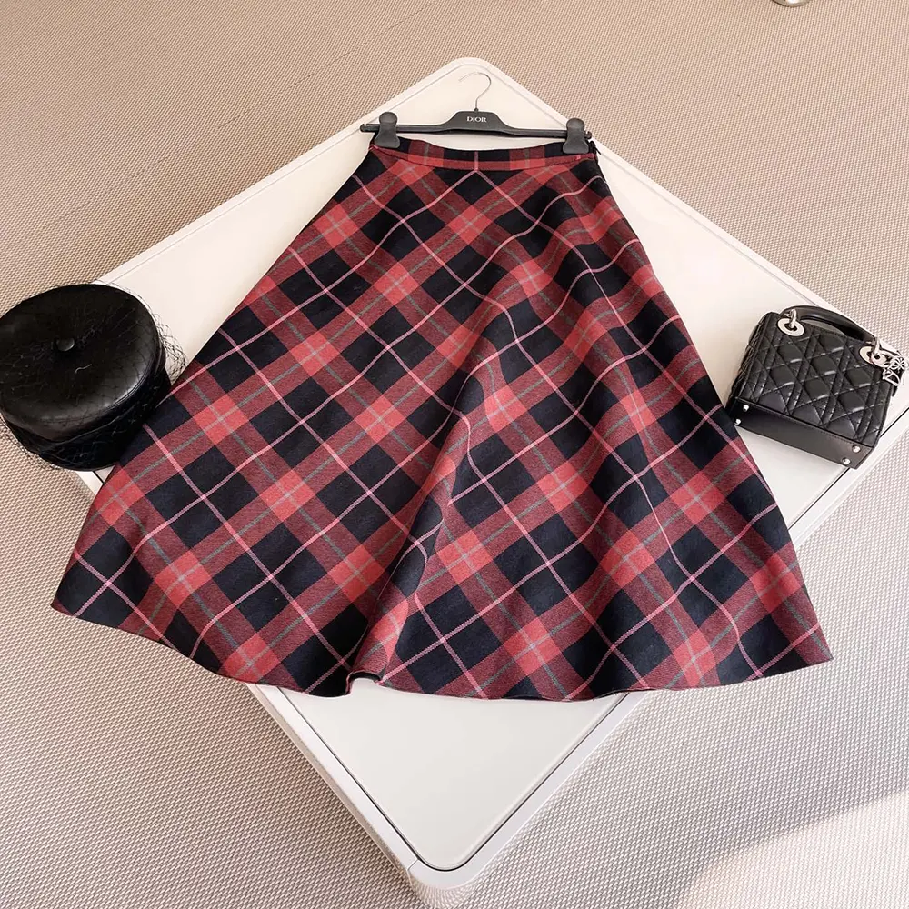 Close-up detail of Check’n’Dior pattern and signature button on Dior flared skirt