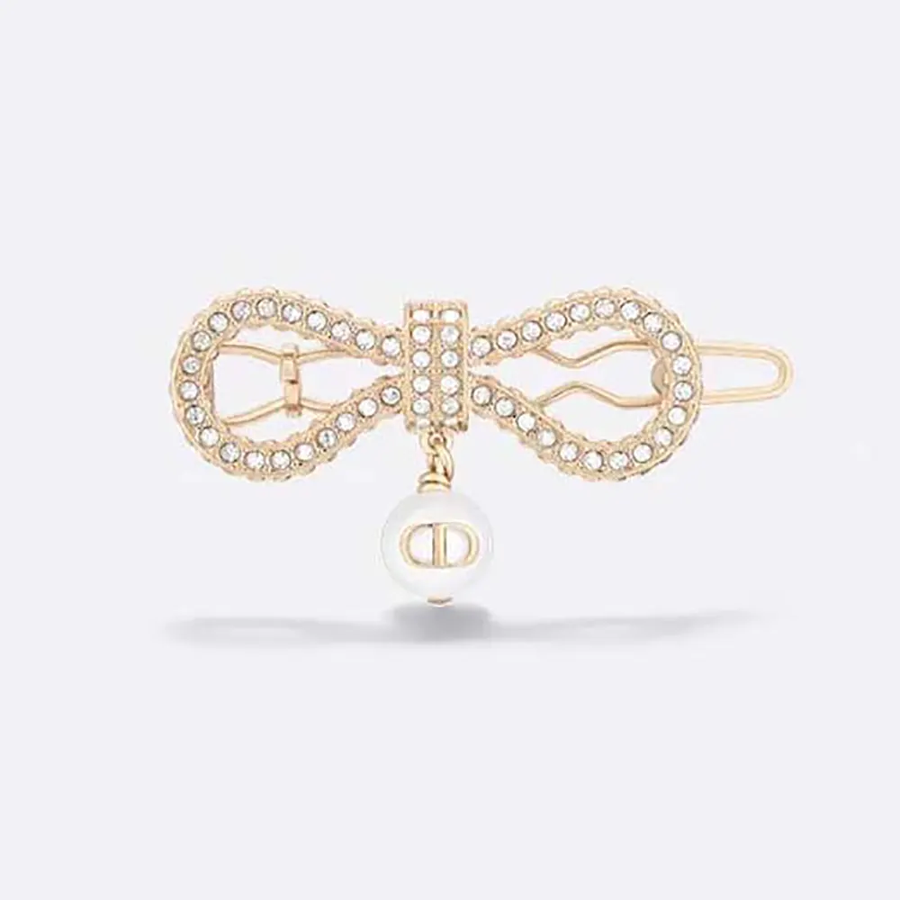 Close-up of Dior Women Le Nœud de Dior Barrette Champagne-Finish metal and pearl