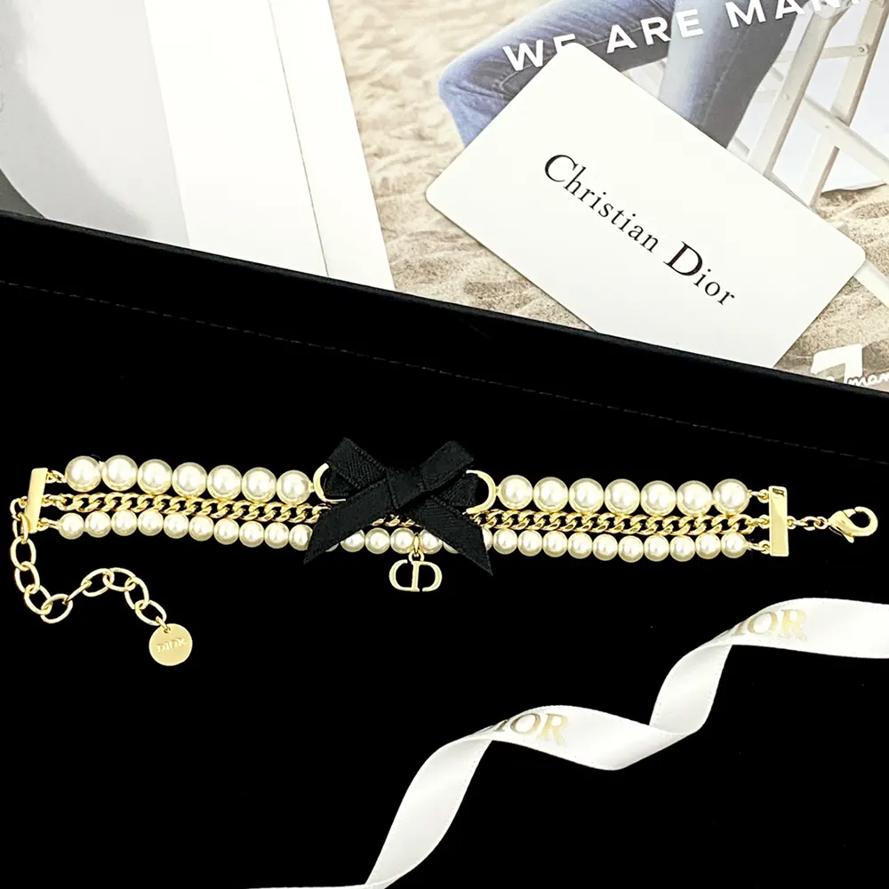 Side angle of Dior Women Le Nœud de Dior Bracelet highlighting gold-finish metal