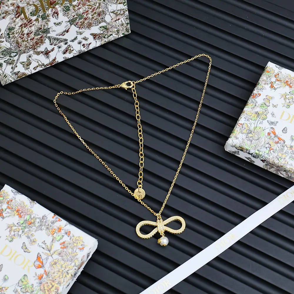Close-up of champagne-finish metal bow on Dior Women Le Nœud de Dior Necklace