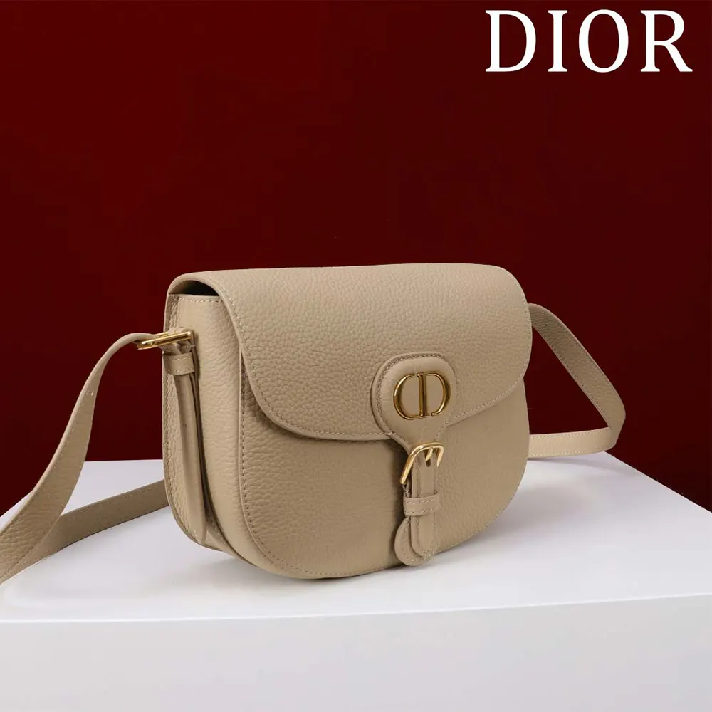 Side profile showing sandy leather texture of Dior Women Medium Dior Bobby Bag Biscuit