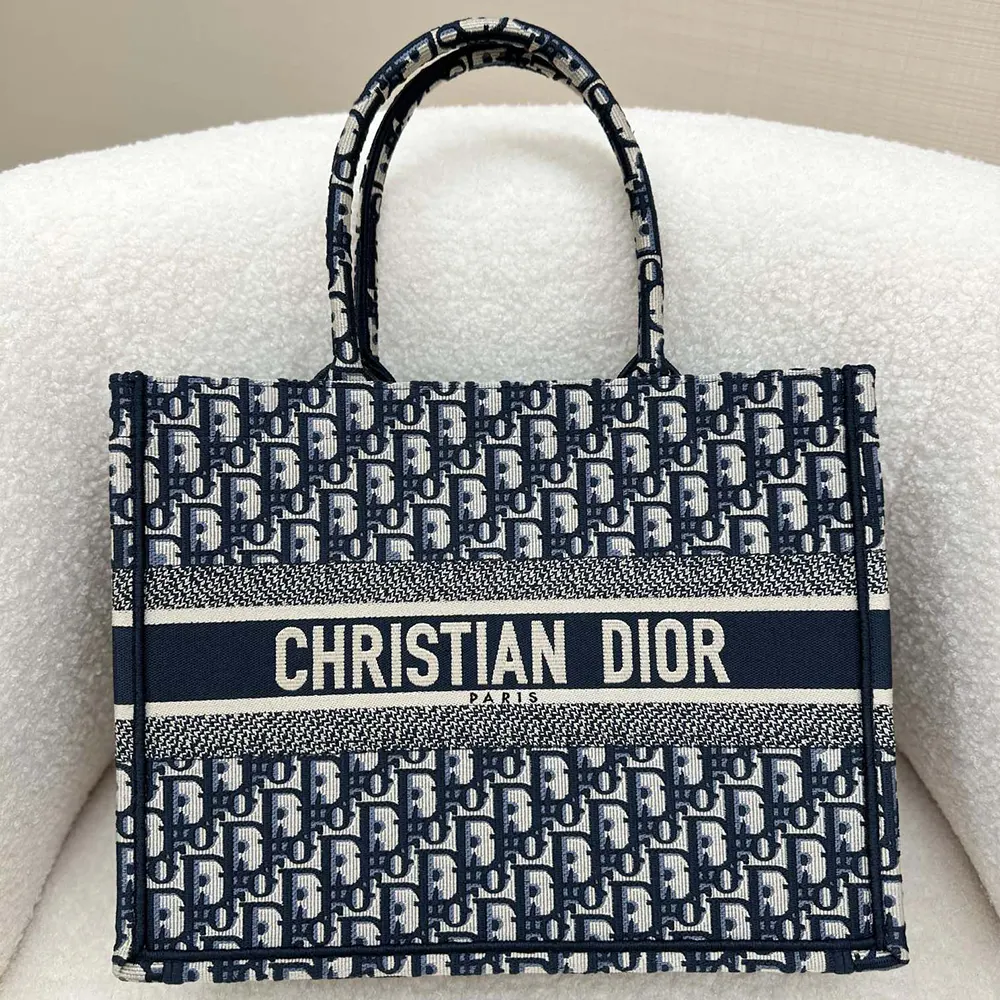 Close-up detail of blue Dior Oblique embroidery on tote canvas