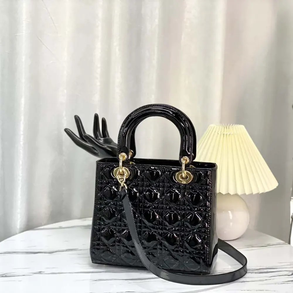 Close-up of silver-tone cannage hardware on Lady Dior Bag in black patent