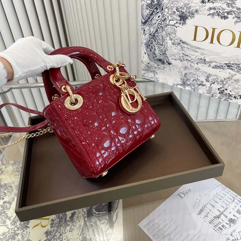 Detail of Cannage quilting and Dior charms on red patent leather bag
