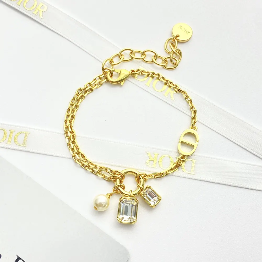 Dior Women Petit CD Bracelet wrist shot with layered jewelry