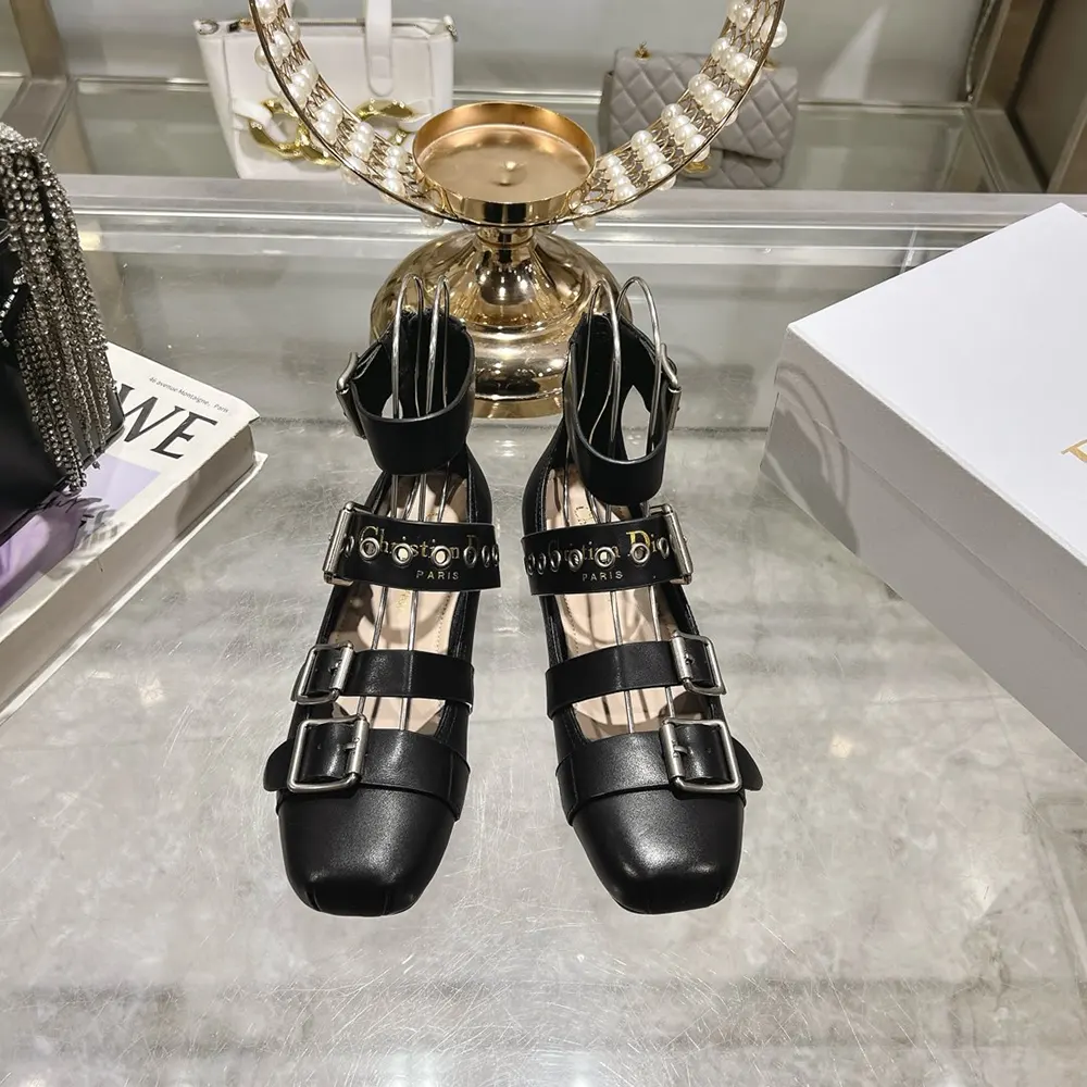 Close-up on supple black calfskin and silver stud detailing of Dior ballet flat