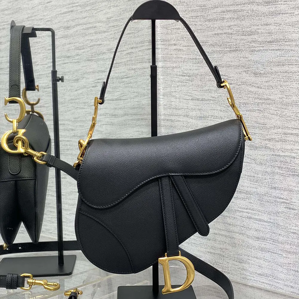 Close-up of gold-tone 'D' hardware on Dior Women Saddle Bag with Strap