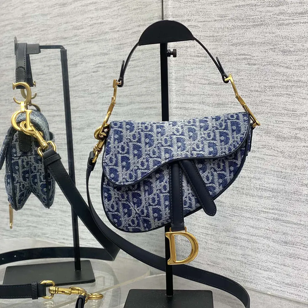 Close-up of silver D hardware on Dior Women Saddle Bag with Strap Blue Denim Dior Oblique Jacquard