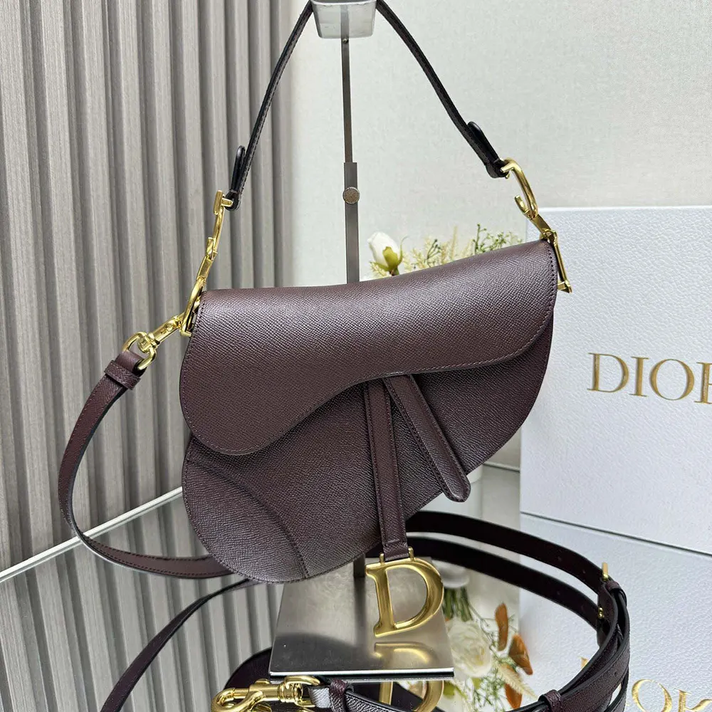 Close-up of gold-tone hardware detail on Dior Women Saddle Bag with Strap Plum Grained Calfskin