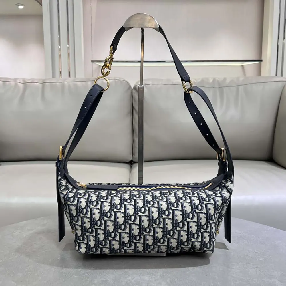 Close-up on silver-tone clasp of Dior Women Small D-Journey Bag