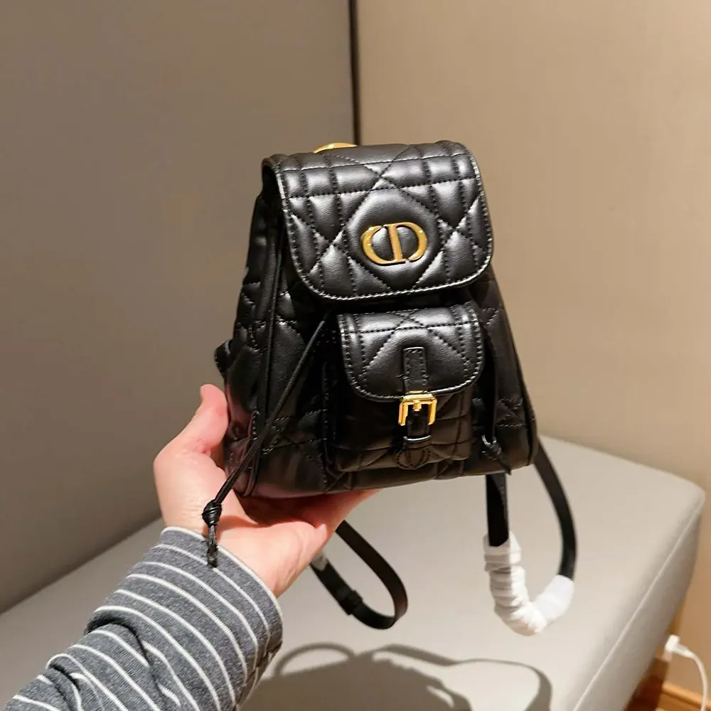 Close-up of black lambskin quilted pattern on Dior Caro Backpack flap