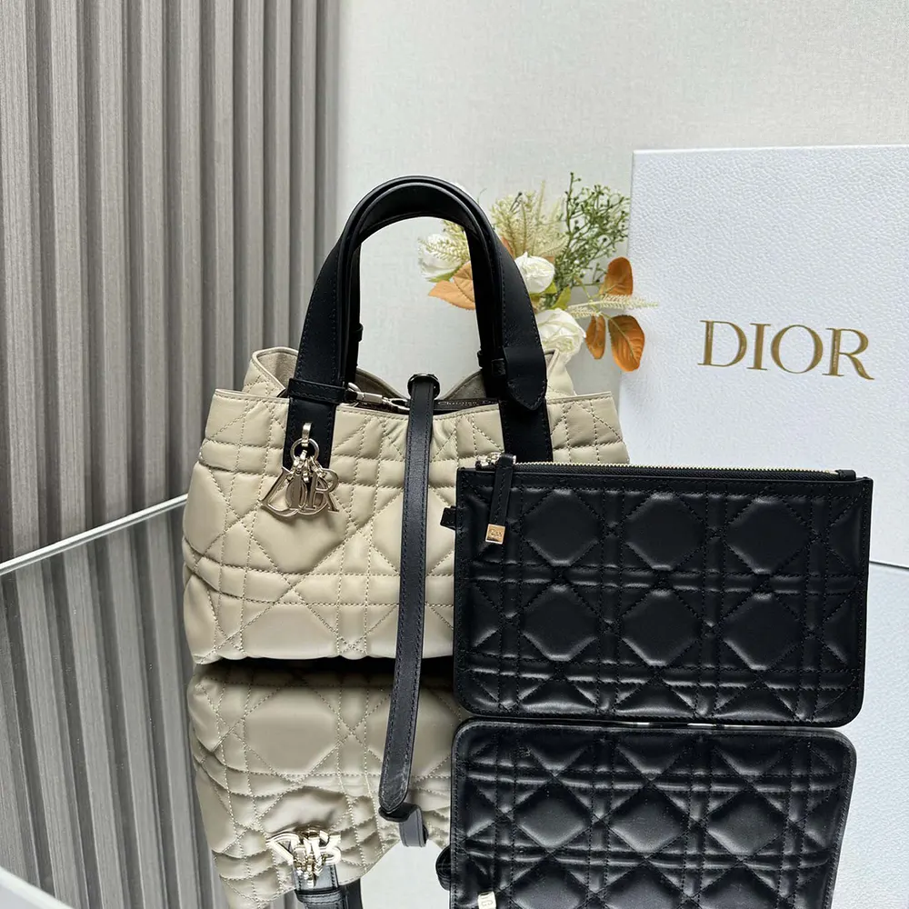 Close-up of black Macrocannage stitching and antique gold hardware on Dior Toujours Bag