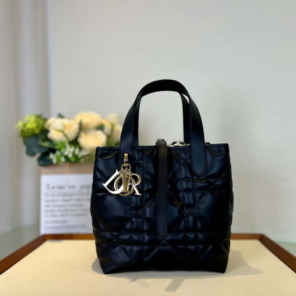 Side angle showing silver hardware and zip closure on Dior Women Small Dior Toujours Vertical Tote Bag