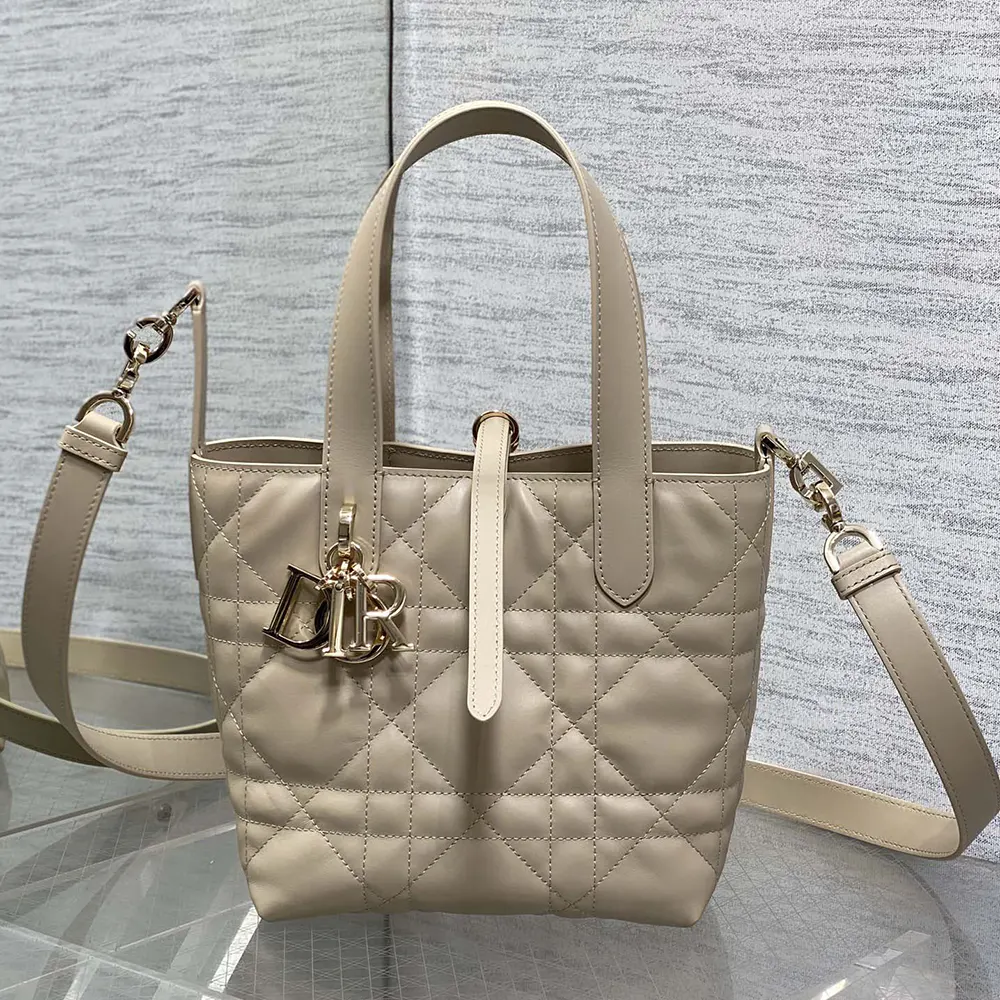 Close-up of macrocannage stitching and gold hardware on Dior Women Small Dior Toujours Vertical Tote Bag