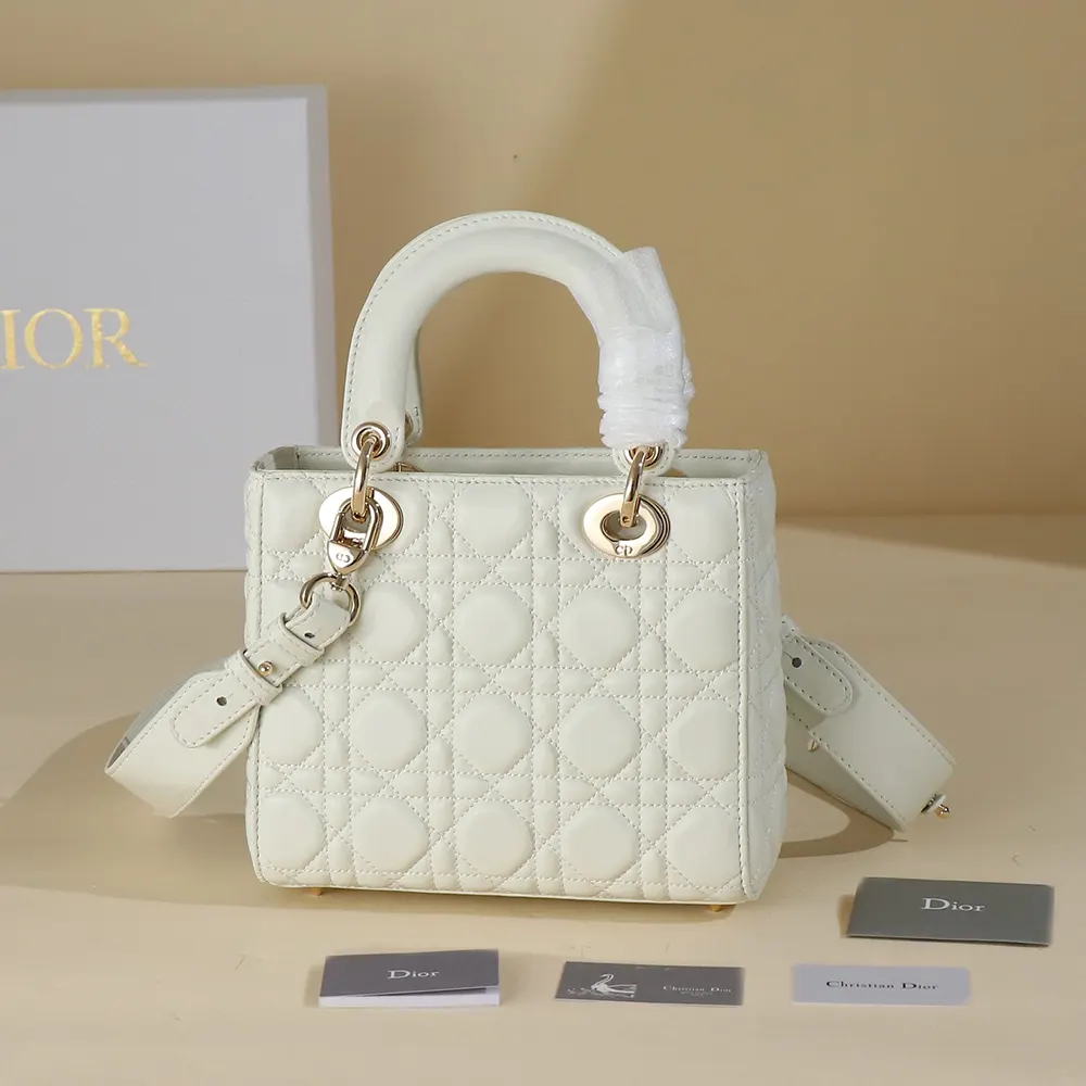 Side angle showing white lambskin and flap closure of Dior Women Small Lady Dior My ABCDior Bag