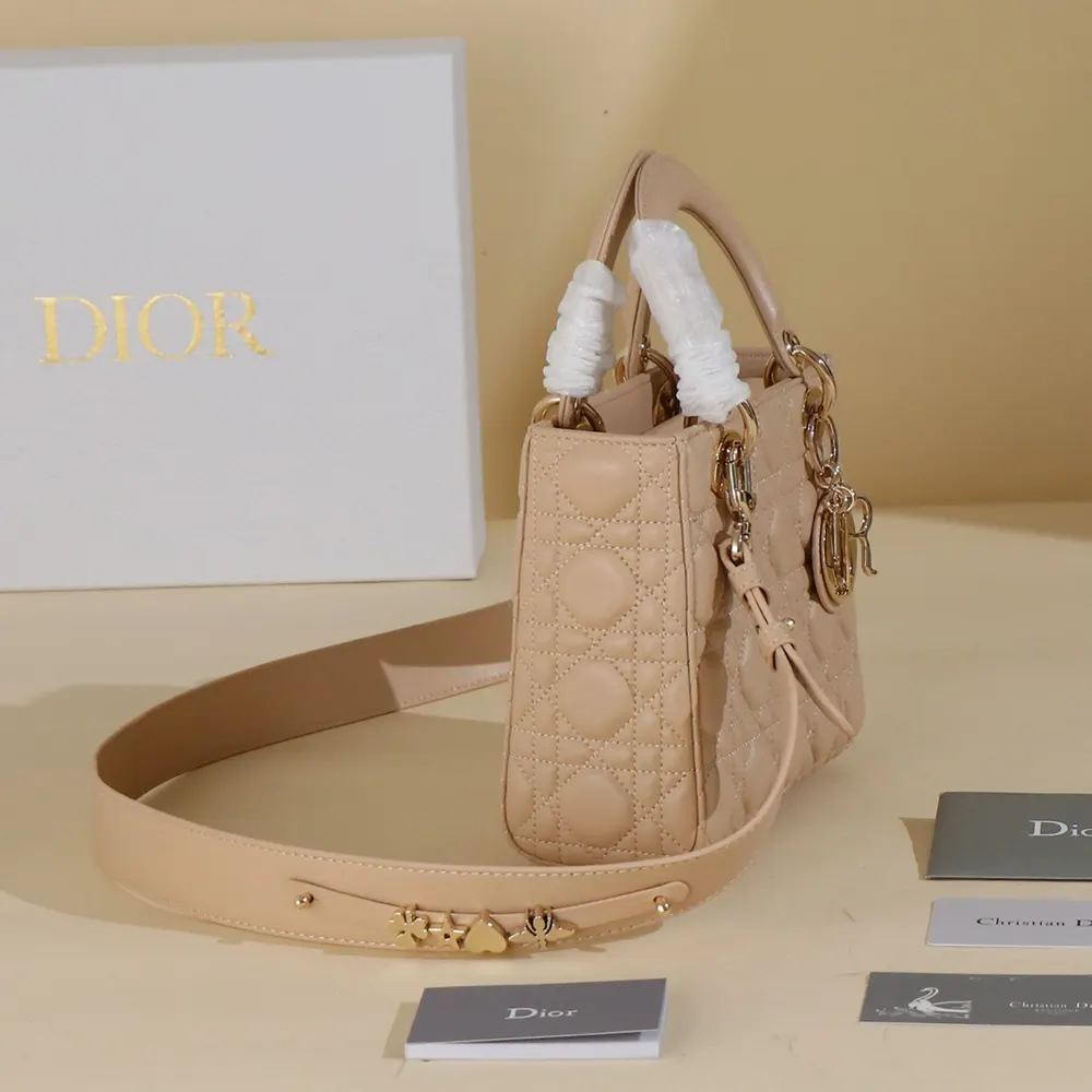 Detail of silver ABCDior charms on sand-colored Dior Women Small Lady Dior My ABCDior Bag