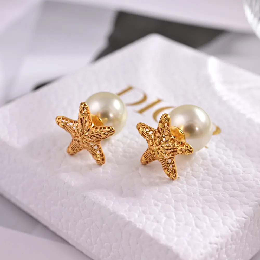 Close-up detail of gold-finish metal and push-back closure on Dior Women Tribales Earrings