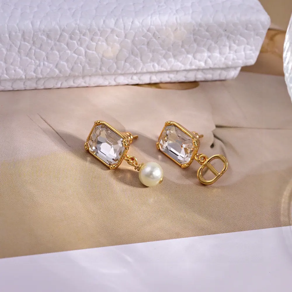 Pair of Dior Women Tribales Earrings displayed on white background with dual-sided design