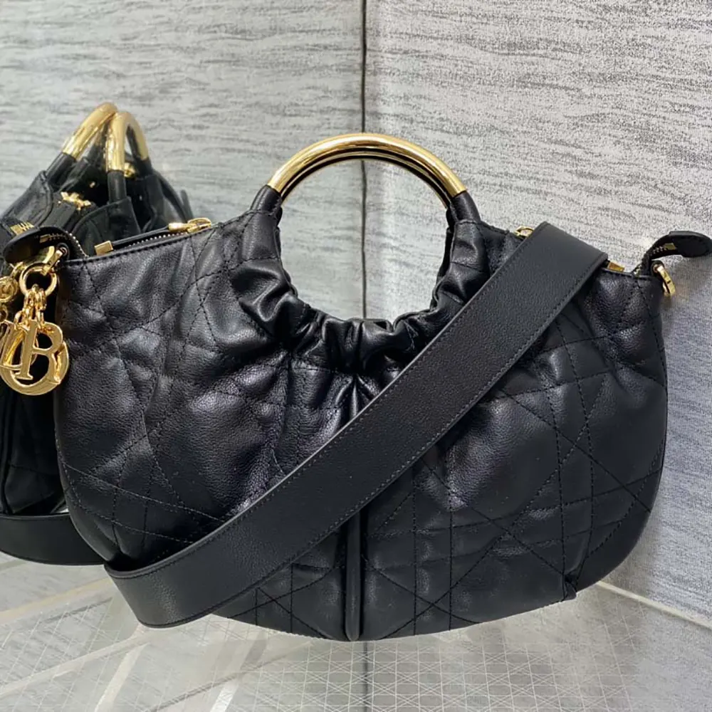 Close-up of black calfskin texture and silver hardware on Dior purse