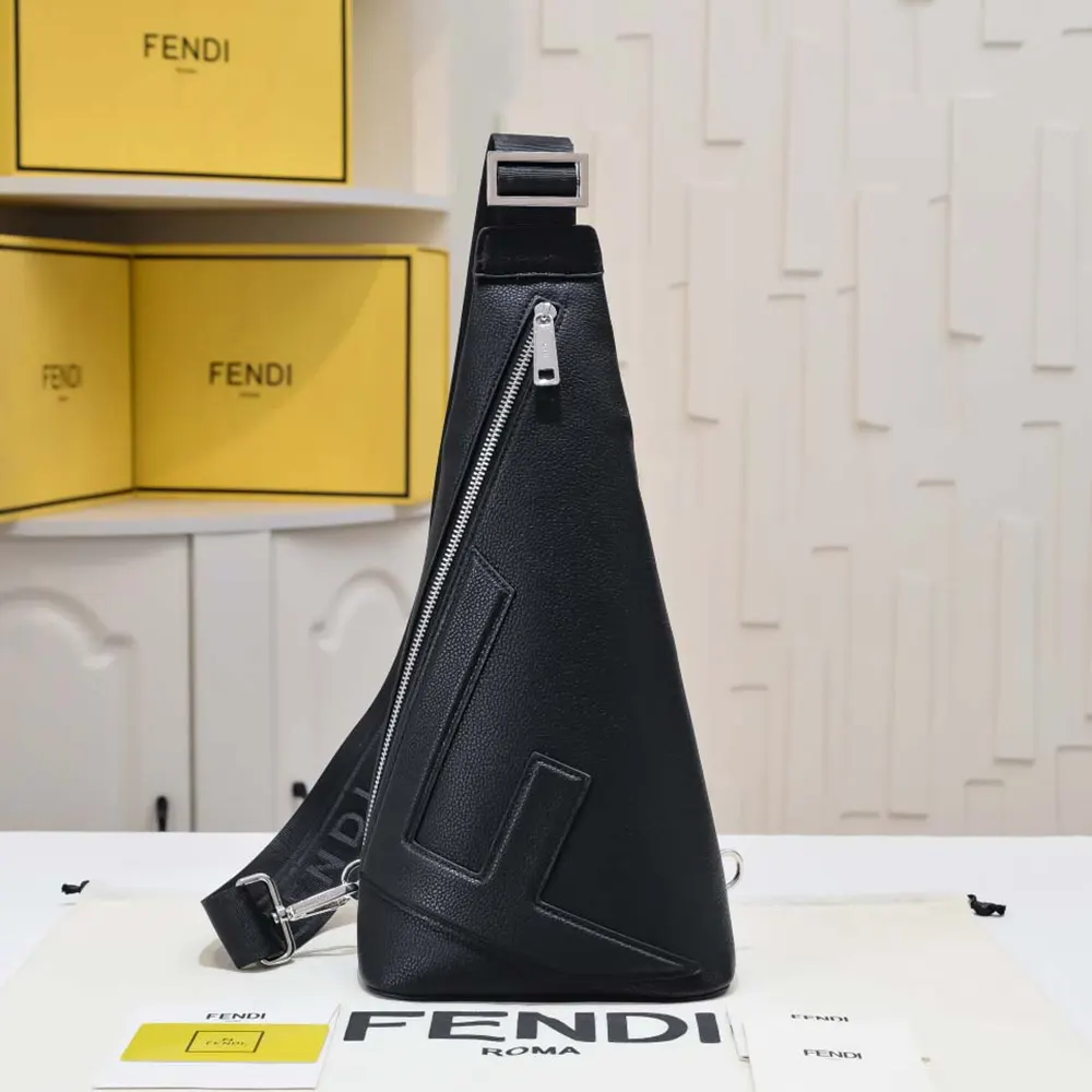 Close-up of silver-tone hardware and engraved Fendi logo on black leather backpack