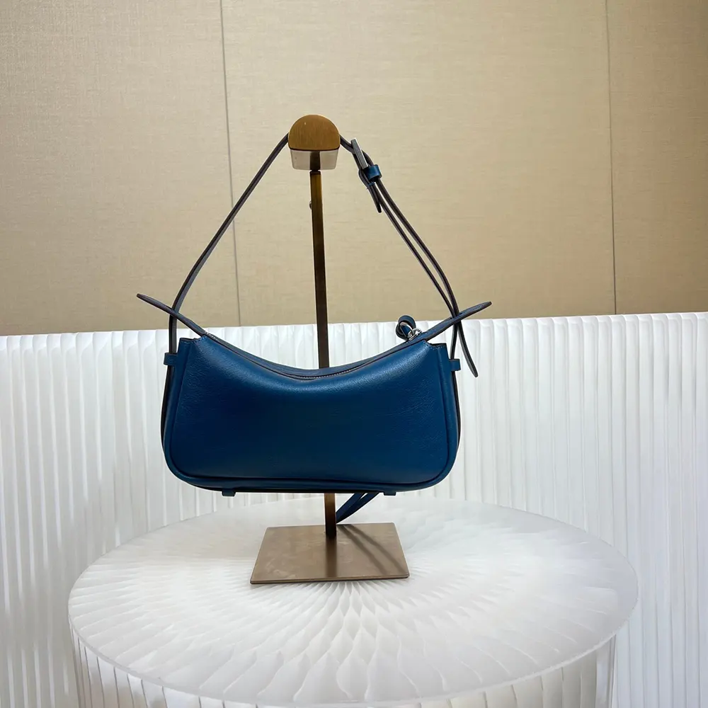 Side angle showing blue leather texture and adjustable strap of Fendi mini-bag