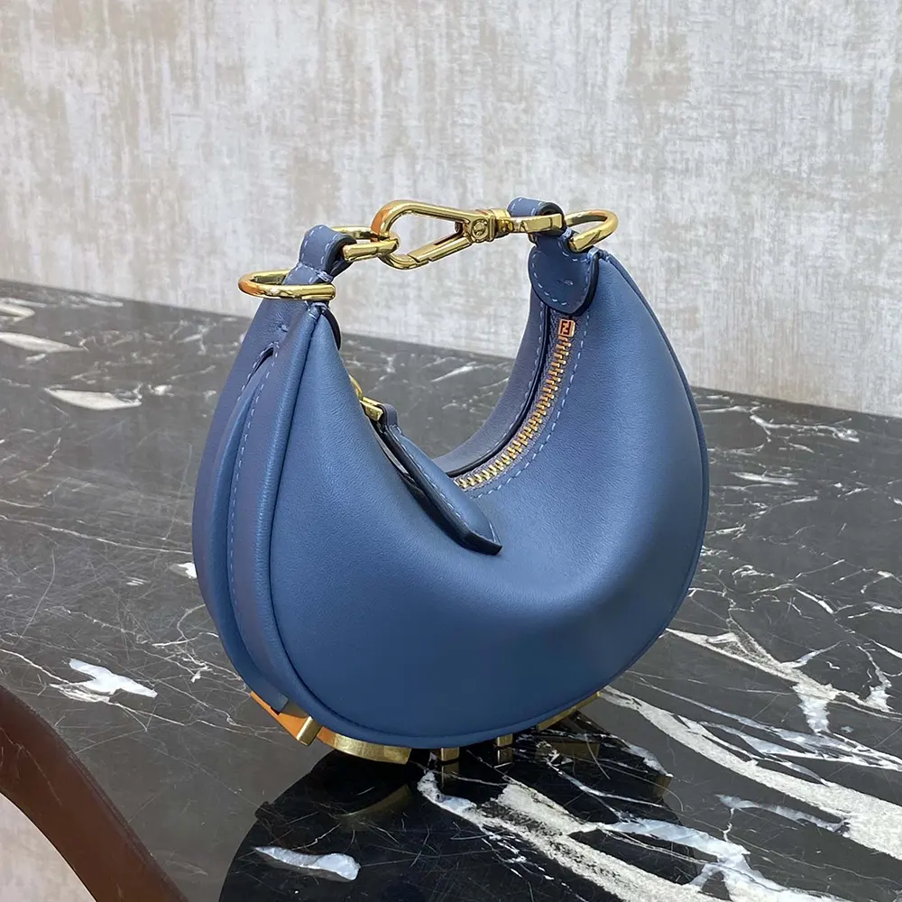 Side profile showing magnetic flap closure on Fendi Women Fendigraphy Mini Blue Leather Mini-bag