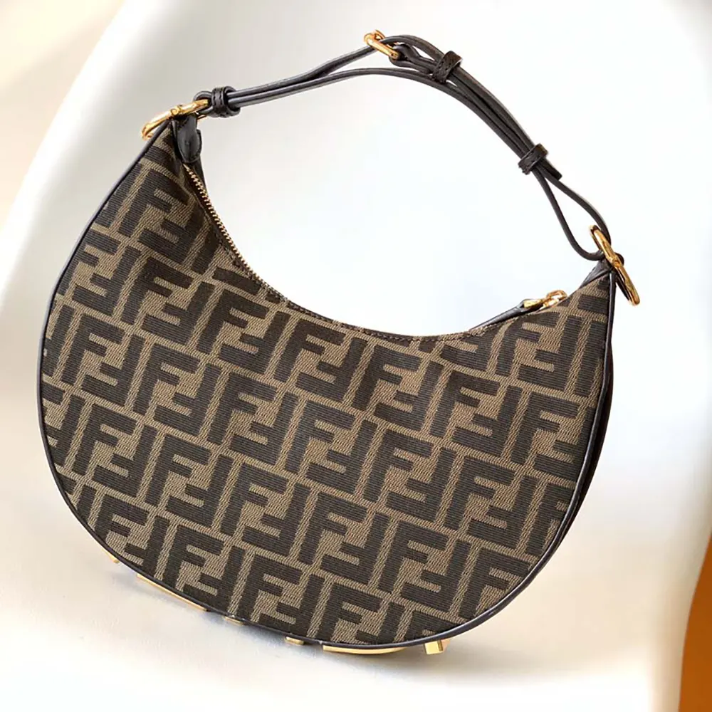 Close-up detail of Fendi FF jacquard fabric on the small brown bag