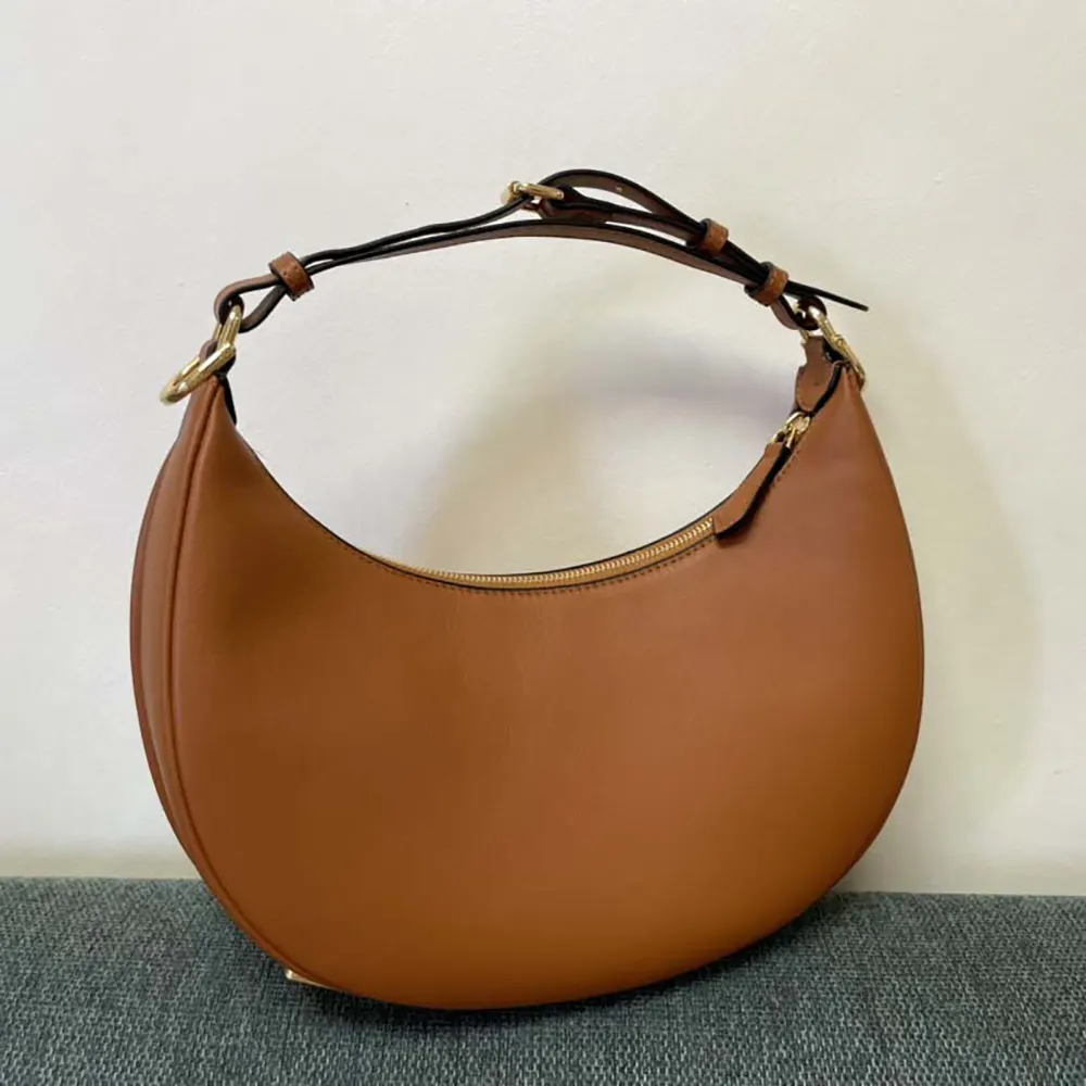 Close-up detail of gold-tone hardware on Fendi Women Fendigraphy Small Brown Leather Bag