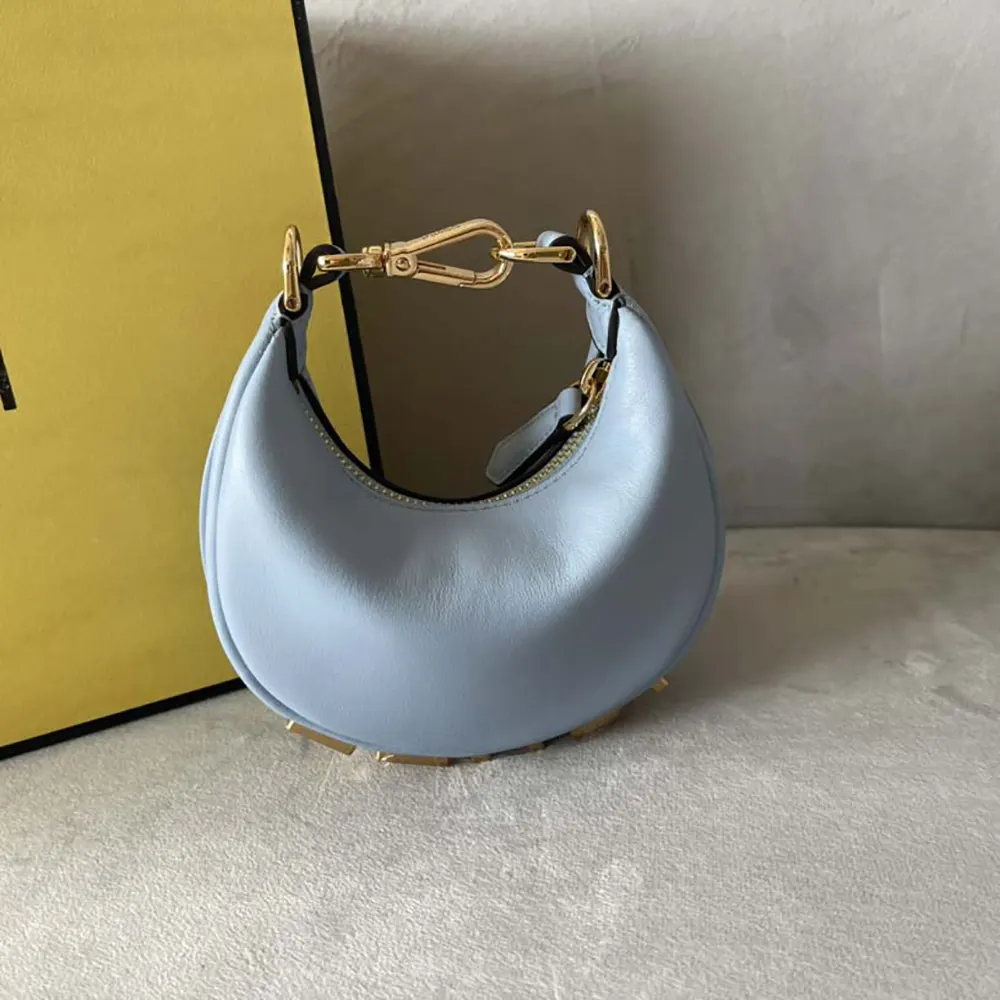 Close-up of Fendigraphy charm detail on blue leather bag