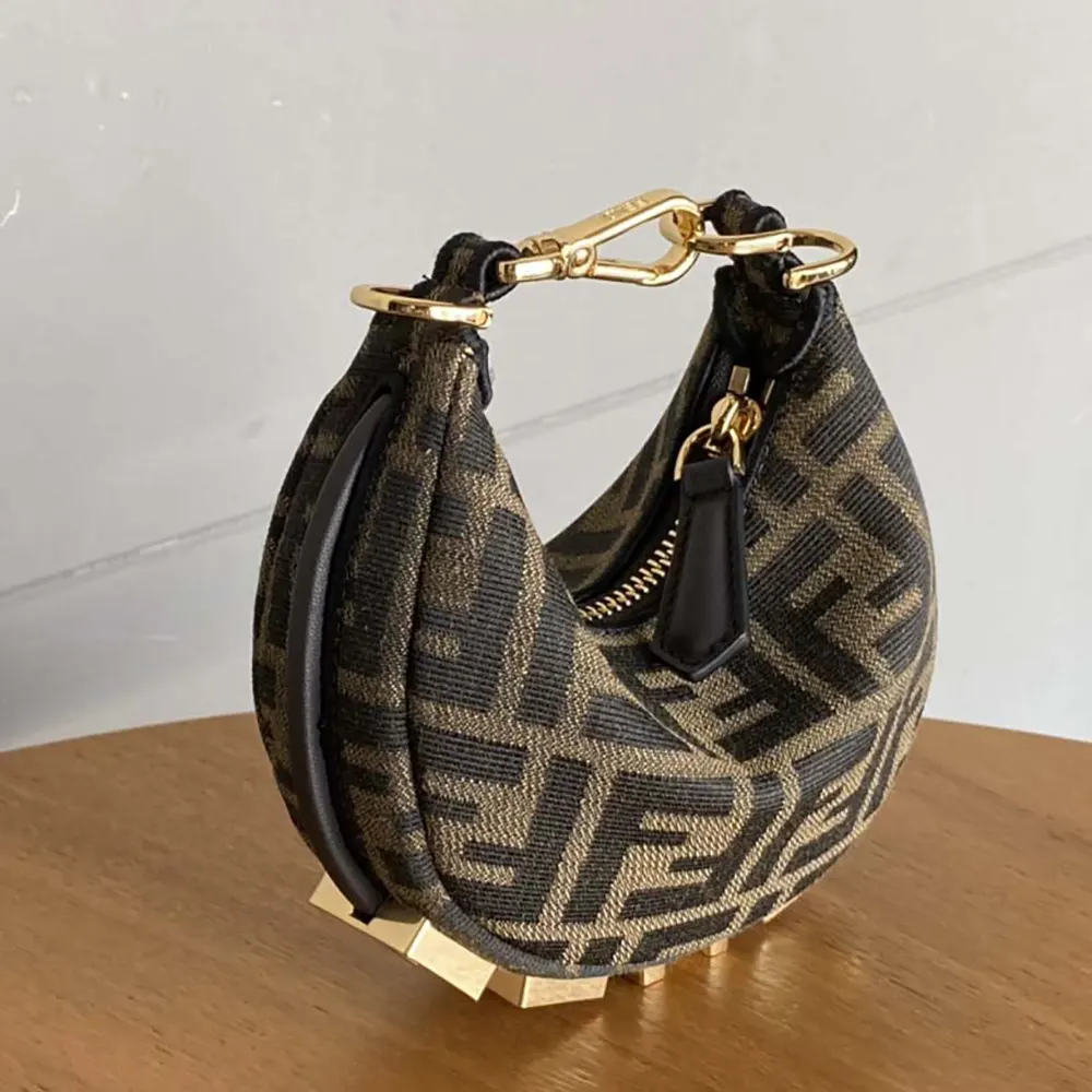 Close-up of gold-tone Fendigraphy charm on Fendi Nano bag