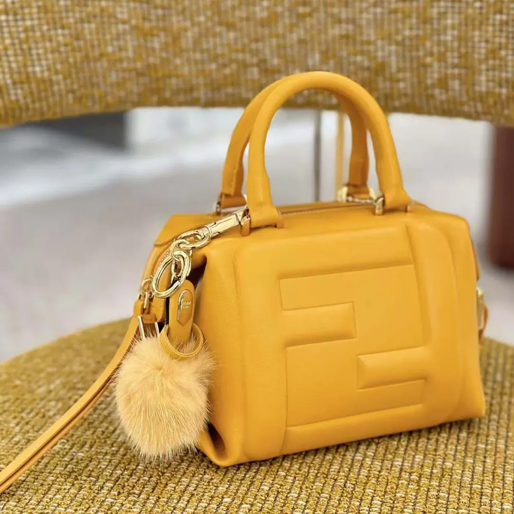 Close-up of gold-tone hardware and orange nappa leather texture on Fendi Mini Cube Bag