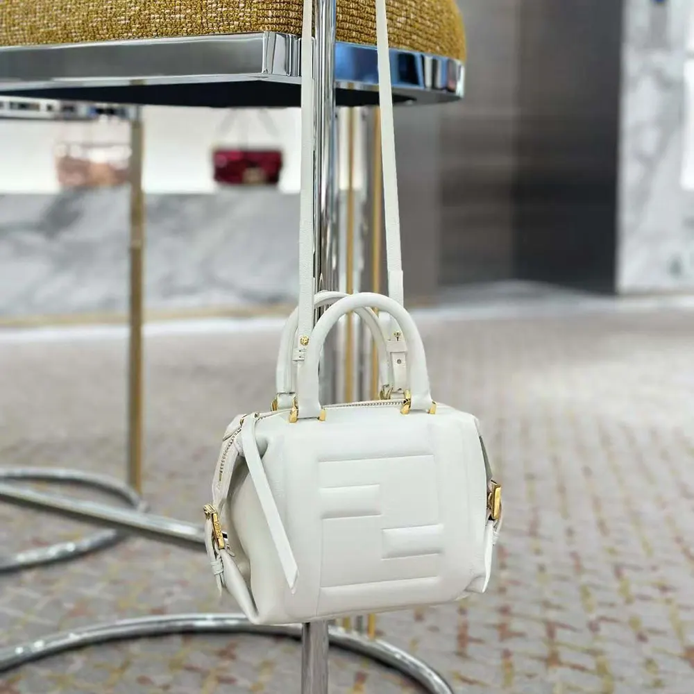 Side angle showing compact silhouette of Fendi Women Nappa FF Mini Cube Bag-White