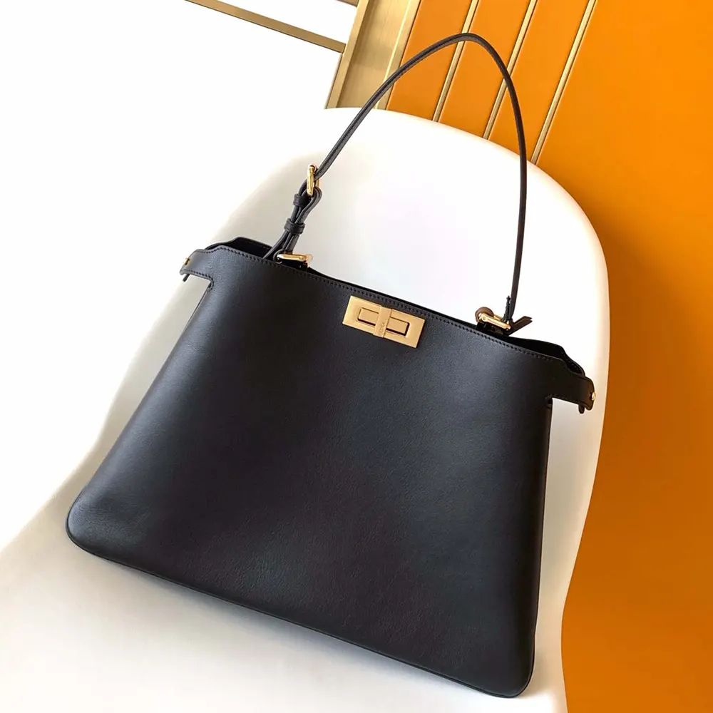 Close-up of gold-tone twist-lock on Fendi Women Peekaboo Soft Large Black Leather Bag