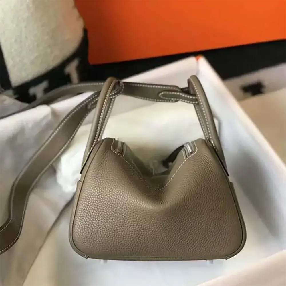 Side profile showing supple Clemence leather texture of Lindy Mini 19