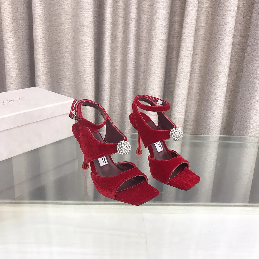 Close-up of ruby red velvet and crystal orb detail on Jimmy Choo sandals
