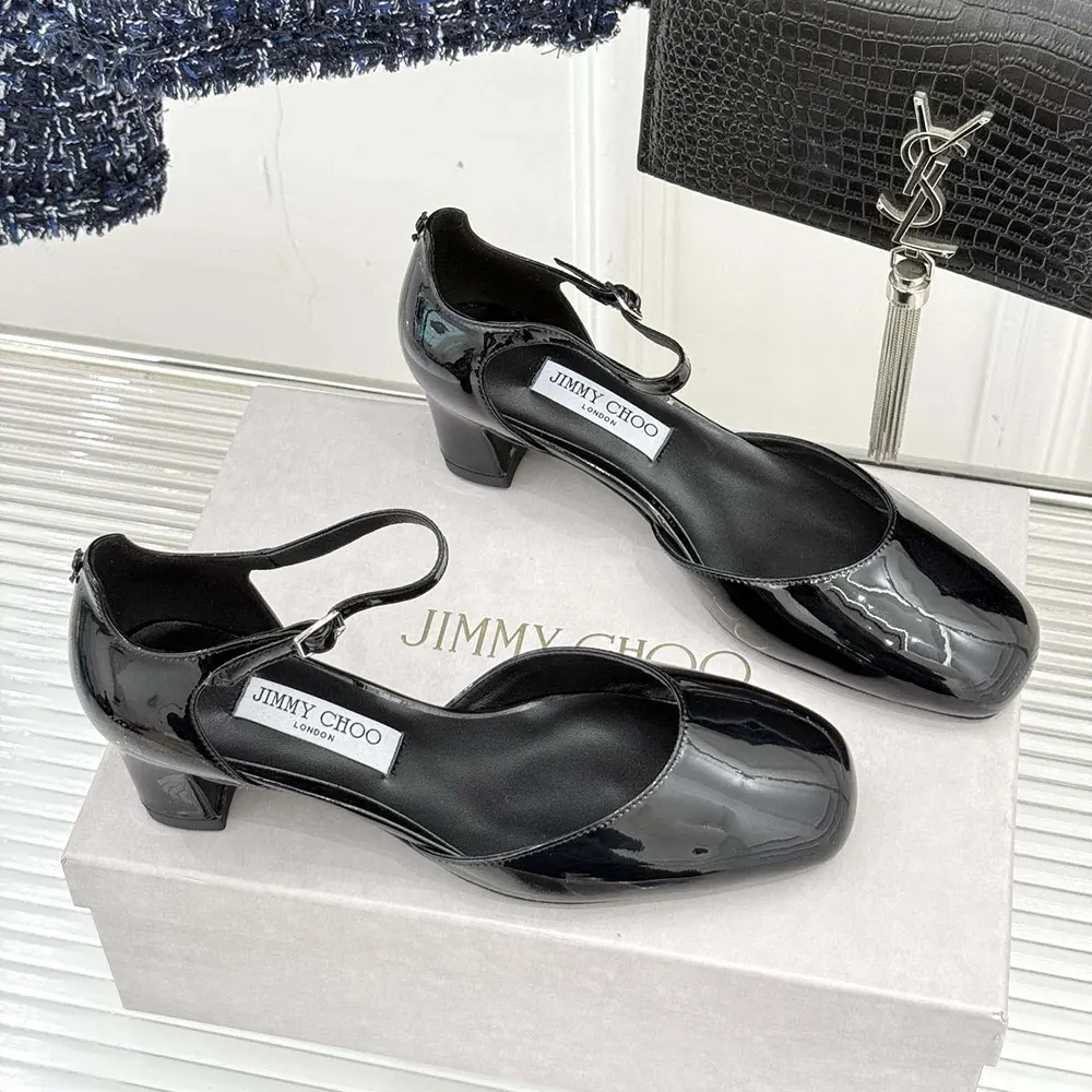 Close-up of shiny black patent leather and block heel detail