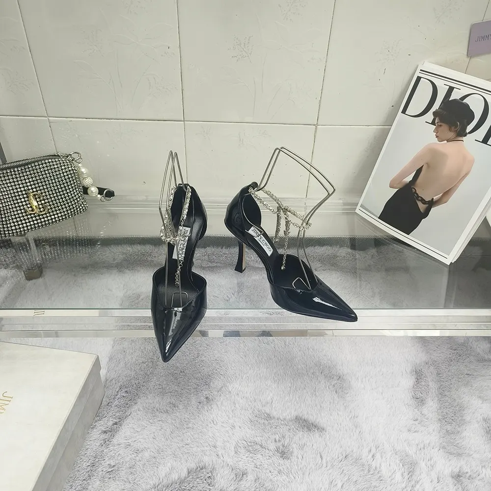Close-up of pointed toe and black patent leather on Jimmy Choo Women Stevie 100 pumps